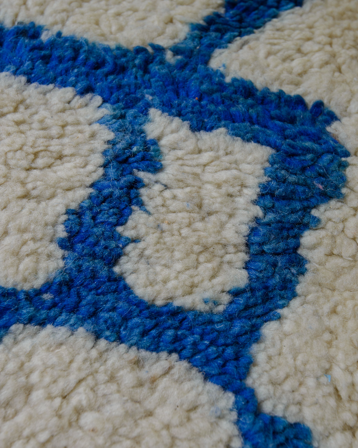 Detail of wool rug showing some discolouration.